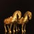 This is a charming pair of vintage Chinese gilt bronze horse figures, crafted in the style of Tang dynasty pottery horses....