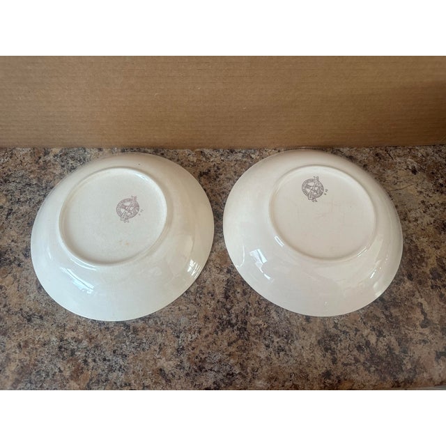 Beautiful pair of vintage ironstone serving bowls featuring a delicate floral border in soft pastel tones. The classic...