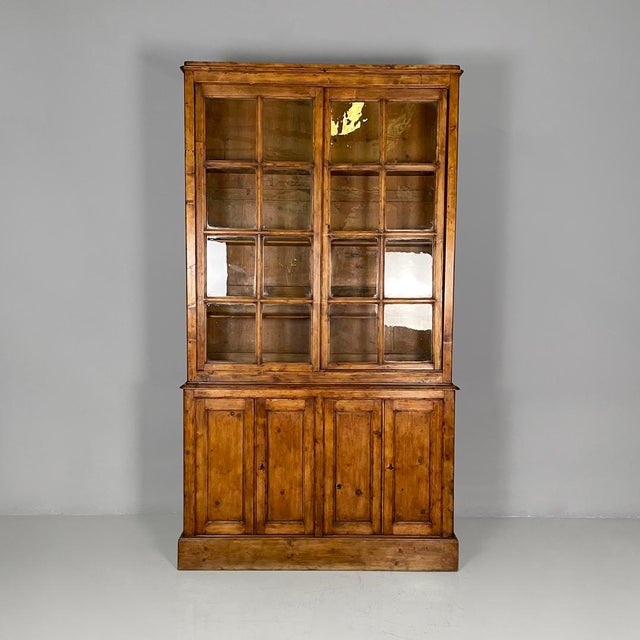 Italian early 19th-century style wooden and glass sideboard, 1930s Sideboard made entirely of solid wood. The upper part...