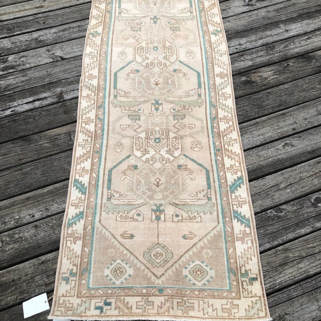 A Neutral Vintage Runner with Stylized Medallions and Soft Patina This vintage runner rug is hand-knotted approximately 80...