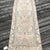 A Neutral Vintage Runner with Stylized Medallions and Soft Patina This vintage runner rug is hand-knotted approximately 80...