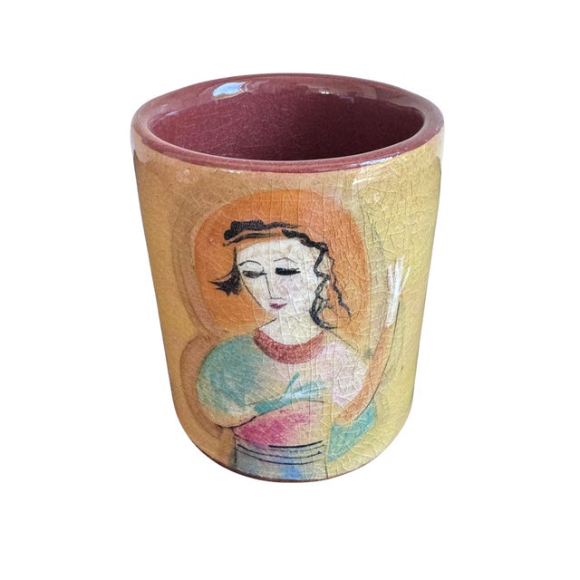 A charming and highly collectible vintage studio pottery vase by Fillin featuring a delicately hand-painted female figure...