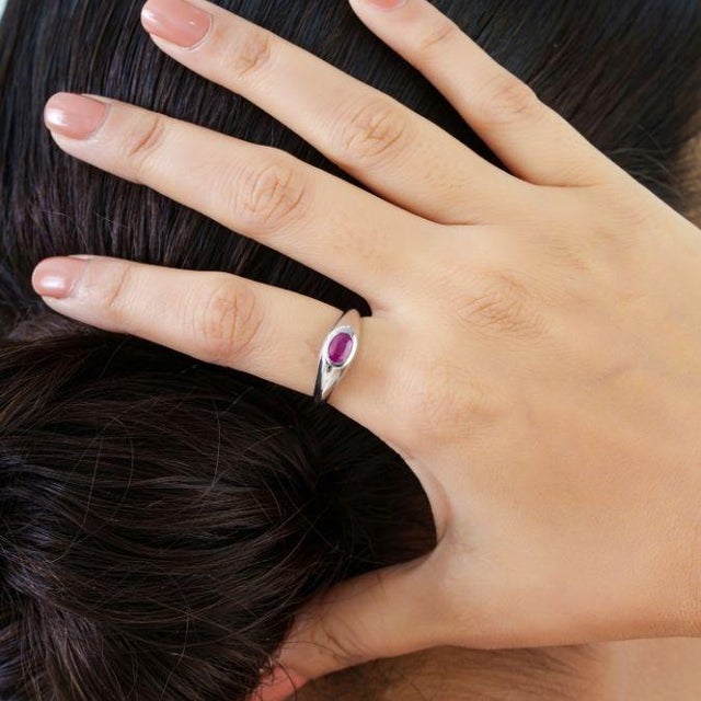 This modern signet ring showcases a 0.74 carat natural Mozambique ruby set in 14K White Gold. The ruby set ina in a gypsy...