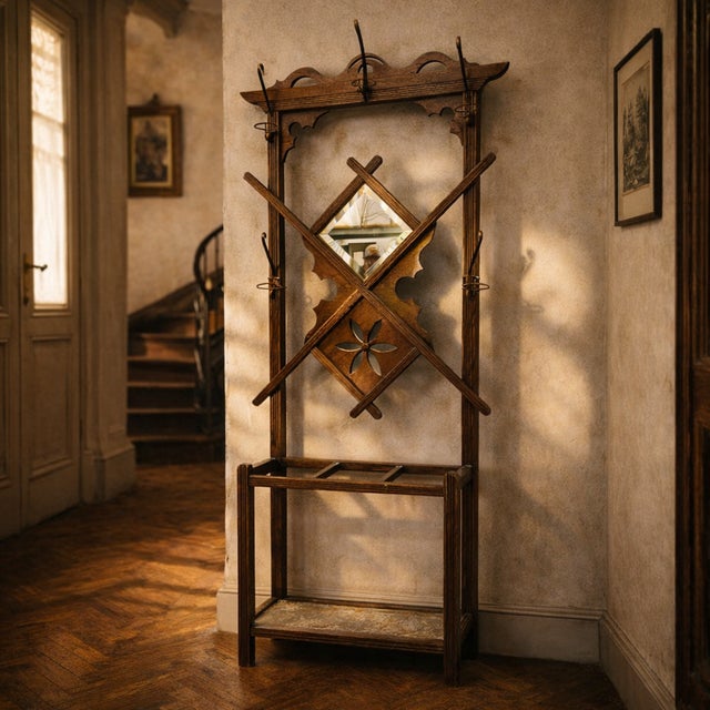 A tall wall-mounted coat rack designed for efficient vertical storage in narrow spaces. This vintage wooden wall hanger...