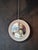 Round mirror made of white lacquered wood and support with steel chain. The mirrored part is bevelled. The diameter of the...