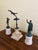 A refined collection of Grand Tour–style metal figures mounted on richly varied marble bases, each piece evoking the...