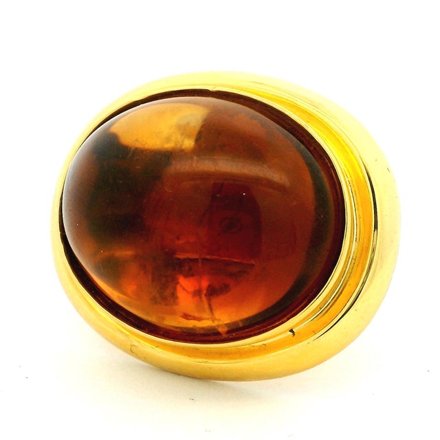 A bold vintage statement ring by TURGO crafted in solid 18 karat yellow gold and centered with a striking large cabochon...