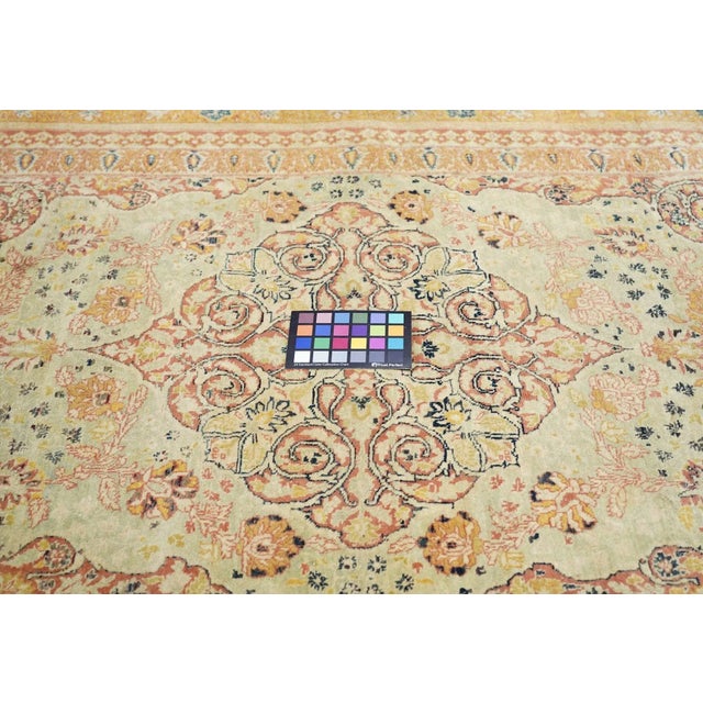 This antique scatter from an esteemed NW Persian city shows a straw field centred by a coral-rust volute medallion. Fan...