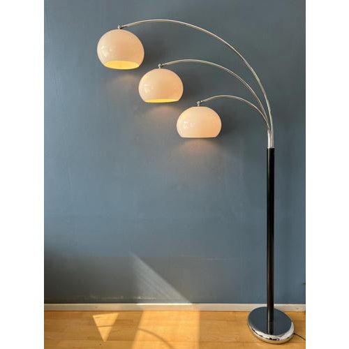 Dijkstra's famous triple arc space age floor lamp with acrylic glass mushroom shades. The shades produce a warm light and...