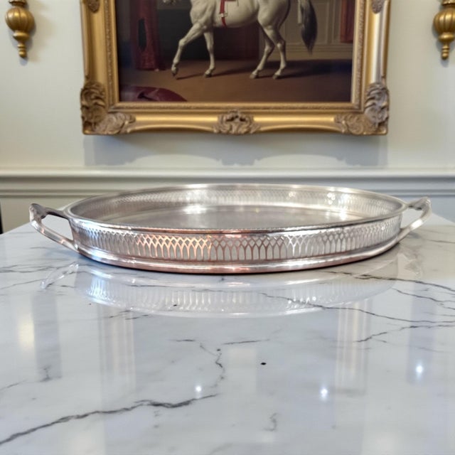 A refined English silverplate gallery tray by Cavalier, marked Made in England. This round tray features a pierced gallery...