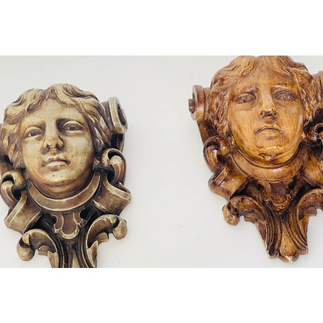 Near pair of figural custom made wall brackets in Beaux Art style. One made in porcelain, the other custom made ceramics...
