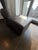 A sleek Room & Board square leather ottoman featuring rich espresso leather upholstery and clean, modern lines. The...