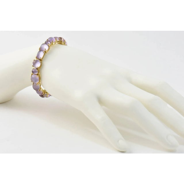 Roberto Coin Shanghai Amethyst Gold Bangle Bracelet features 42 carats of amethyst mounted in a 18k yellow gold. This...