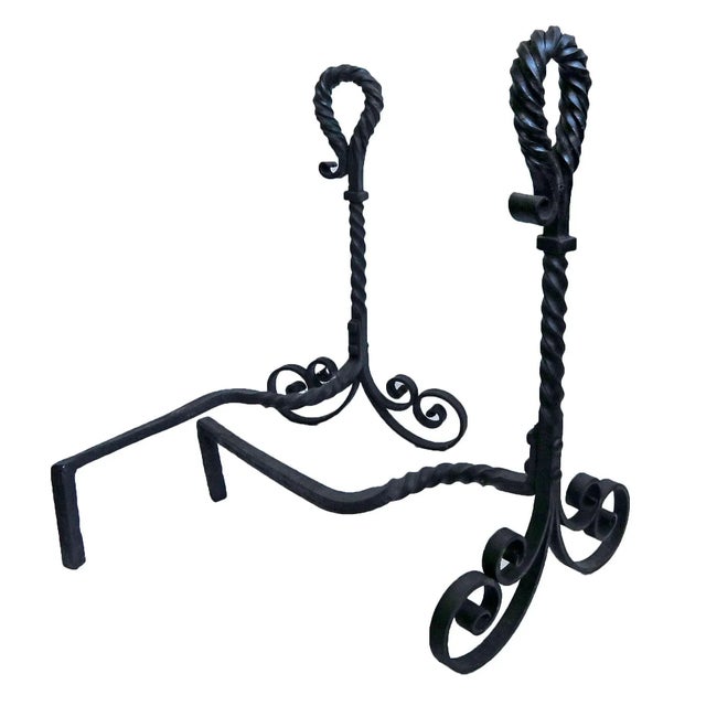 Pair of antique hand wrought andirons. Twisted, curled and turned wrought iron with swirl design. Circa 1920's.