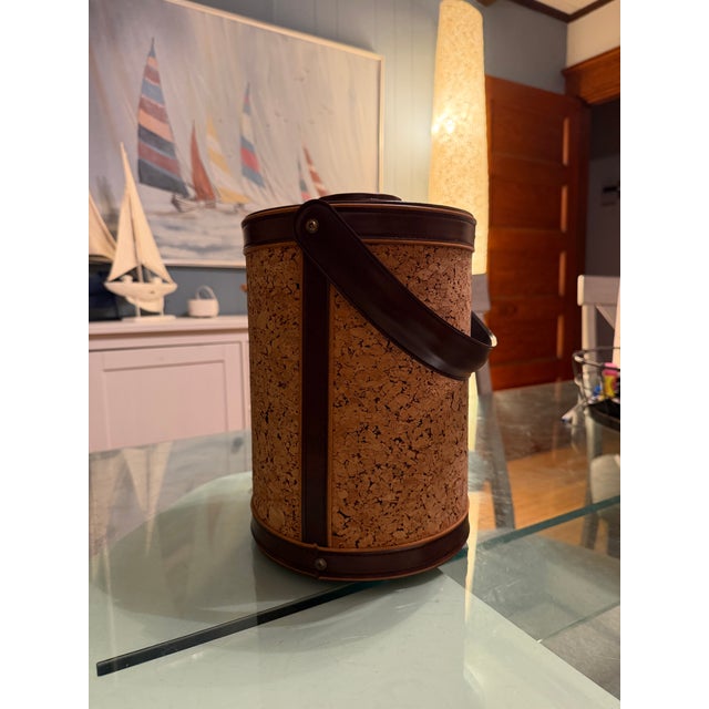 Mid century cork and brown leather ice bucket by Georges Briard. In pristine condition! H: 11” D: 8”