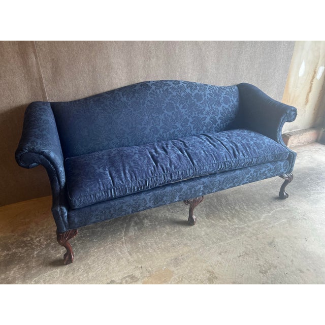 Gorgeous vintage Chippendale Style camelback settee upholstered in sapphire blue floral damask with carved mahogany legs,...