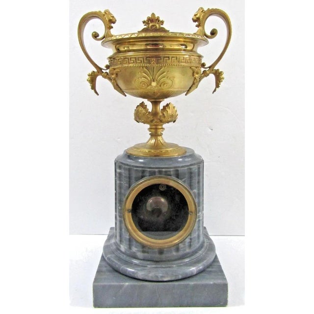 This French Empire Gilt Bronze Brûle-Parfum Onyx Columnar Mantle Clock from the early 19th century is a stunning piece of...