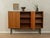 Classic sideboard from the 1950s. Walnut veneer body with two cabinet doors, four shelves, and new black square steel...