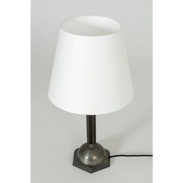 Elegant table lamp from C. G. Hallberg, made from pewter and ebony in the handle. Nicely decorated with geometric lines....