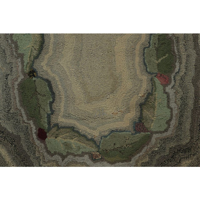 This 3x5 antique oval hooked rug is an exciting new addition to Rug & Kilim’s Antique collection—a rustic folk-art...