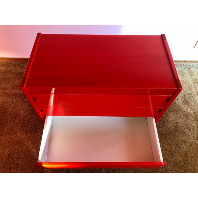 Rare modern six-drawer dresser in bright red. This unique piece features inset drawer handles, an intense aniline dye...