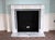 This small scale English Regency style mantel is carved from white marble with rich gray veining. The design of the mantel...