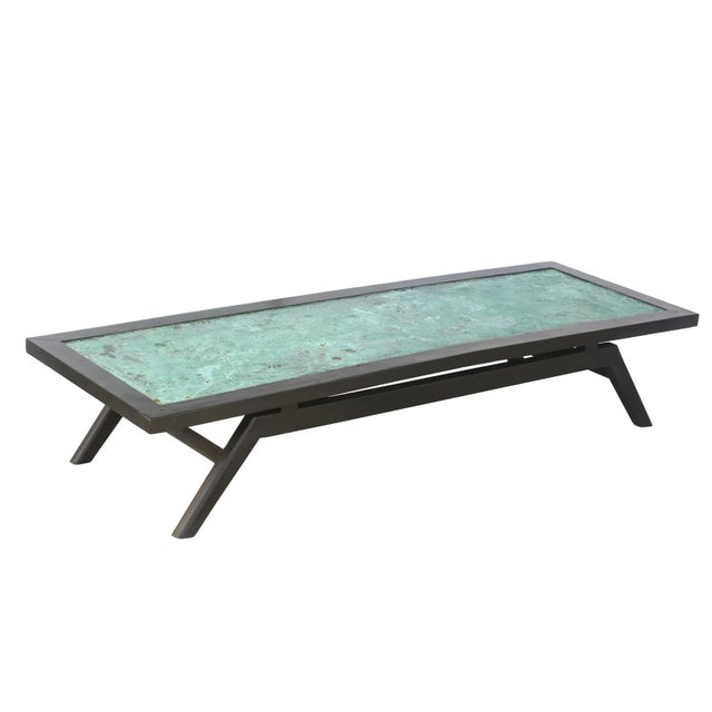 This fabulous sculptural vintage rectangular cocktail table is from the 60's. The wood was re stained black and the top is...