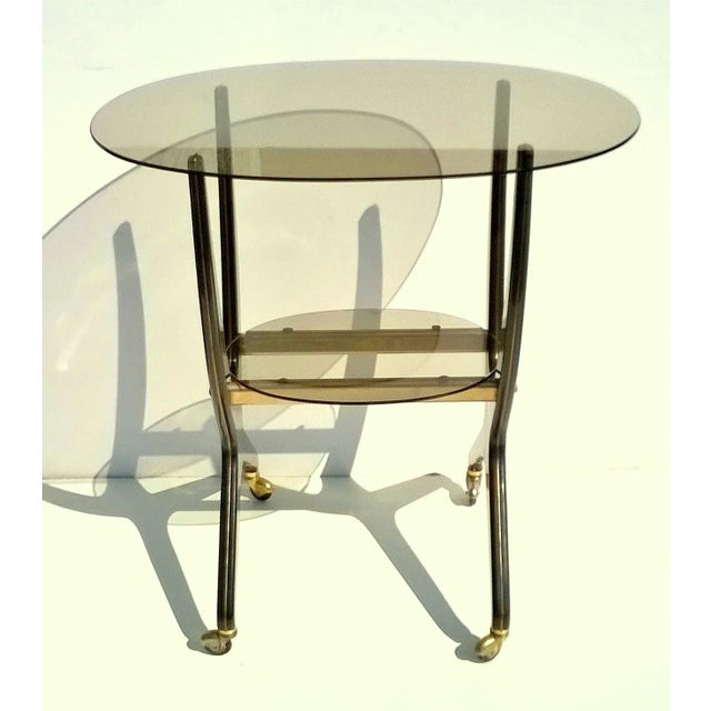 Rare bar cart trolley with wheels and double shelf in smoked glass. Attributed to Cesare Lacca, 1950s. Very good...