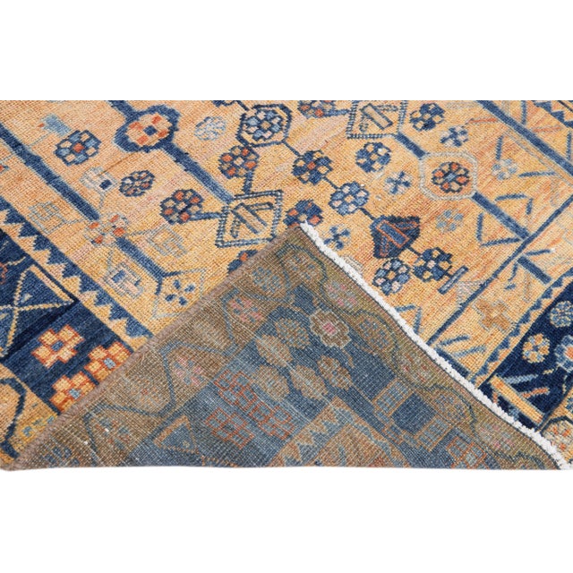 Beautiful vintage Persian Bidjar hand-knotted wool rug with a brown field. This piece has a navy blue frame and multicolor...