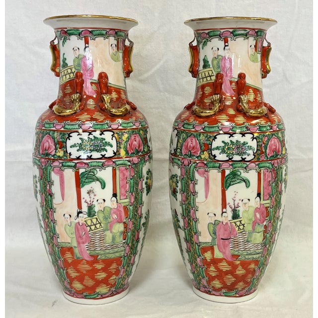 Elegant pair of mid century Asian Famille Rose signed porcelain vases. Each has four panels depicting various Asian...