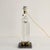 A sophisticated exercise in geometry and transparency. This 1970s table lamp perfectly embodies the optimism of the Space...