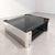 An elegant Italian coffee table from the 1970s, crafted from smoked glass and chrome-plated metal, featuring a refined...