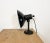 Industrial adjustable table lamp from former Czechoslovakia made during the 1950s. It features a black enamel shade with...