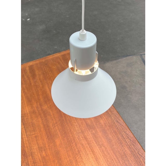 A simple pendant lamp by the Danish manufacturer Louis Poulsen. The lamp consists of two elements: a base and the shade....