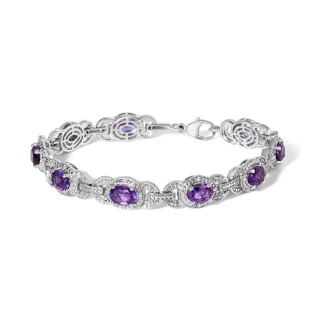 Imbued with an air of majesty, this radiant bracelet showcases oval-shaped purple amethysts, each stone a window to a...