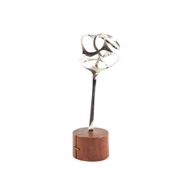A 1963 sterling silver abstract sculpture by the American artist Ned Griner (1928-2017). This sculpture features a...