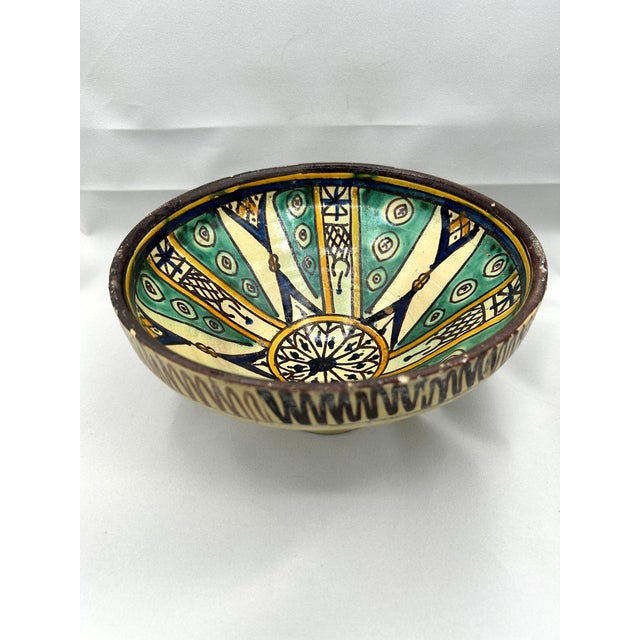19th-century ceramic bowl from Fez, Morocco, exemplifies the intricate craftsmanship of Mokhfia polychrome pottery....