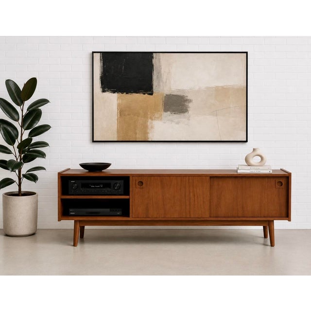 Modern walnut mid century styled media console in a difficult to find low height, featuring clean architectural lines and...