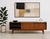 Modern walnut mid century styled media console in a difficult to find low height, featuring clean architectural lines and...