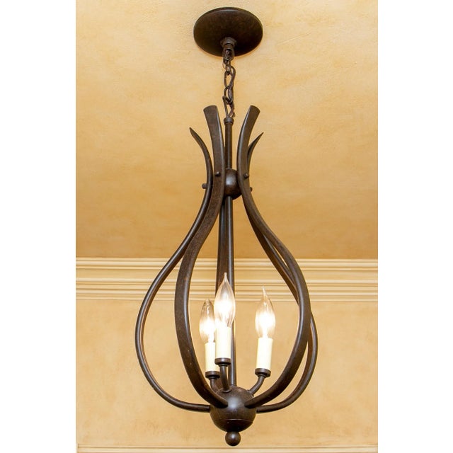 Pair of open work bronzed finish three light pineapple form pendant fixture with ceiling plate and a ball terminal....
