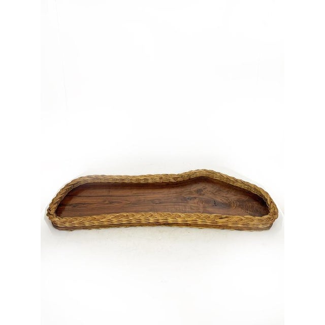 Handcrafted tray in olive wood and woven wicker, made in France in the 1960s. This stunning vintage tray combines the warm...