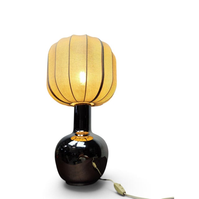Specifications This Italian table lamp from the 1970s features a striking silver-glazed ceramic base. The design captures...