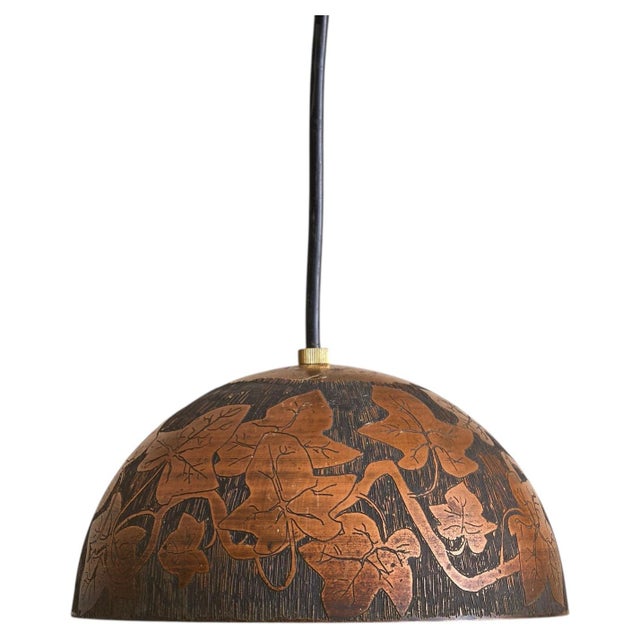 An Italian pendant light from the Turin workshop of Victor Cerrato, dating to the 1960s. The domed copper shade is etched...