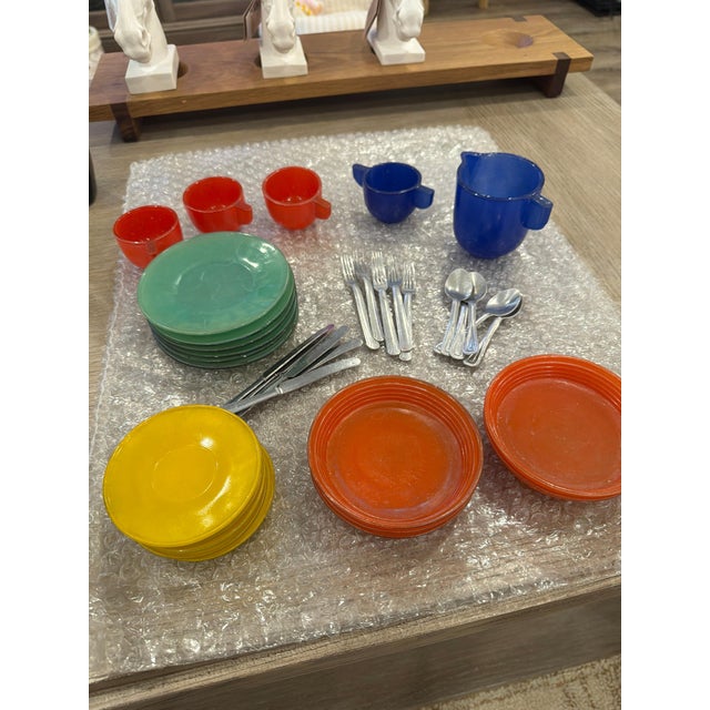 A vibrant, multi-colored vintage child’s toy tea set produced by J. Pressman & Co. during the 1930s–1940s Depression era....