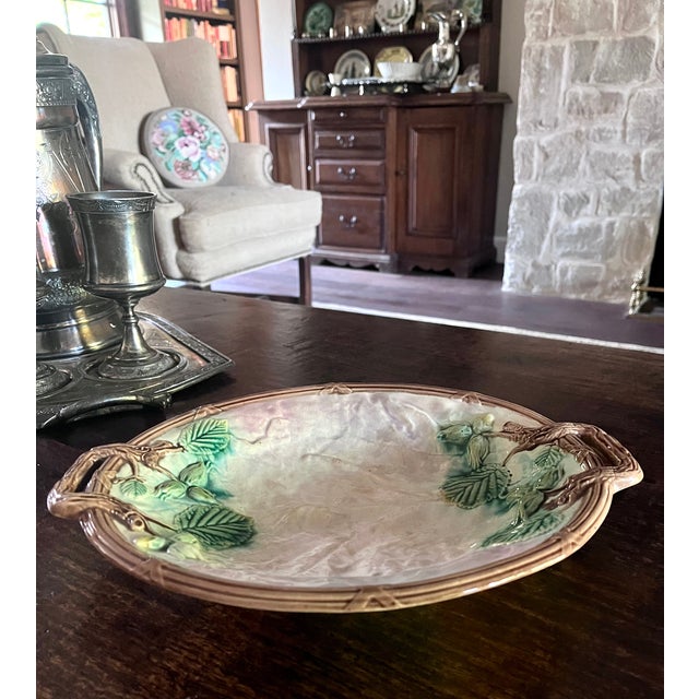Imported from France. Antique hand painted majolica plate. Embossed with leaves and branches which form the handles. Vivid...