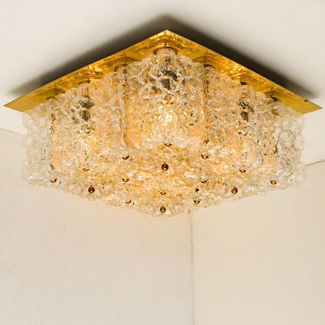 Mid-Century Modern textured ice glass light fixture by German manufacturer Kaiser, circa 1965. This ceiling light, often...