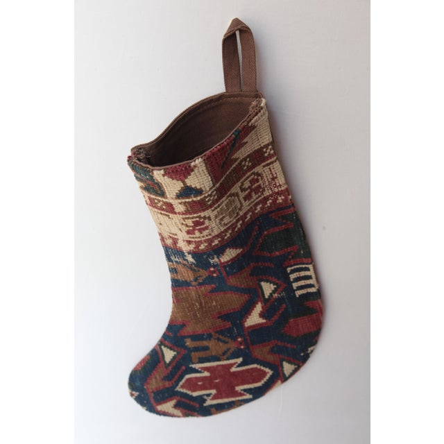 Celebrate the season with this one-of a kind Christmas stocking, handcrafted from a genuine antique tribal rug. Rich in...