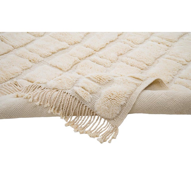 Texture that reveals itself only up close. Rounded, organic shapes rise gently across this tonal ivory piece, their raised...