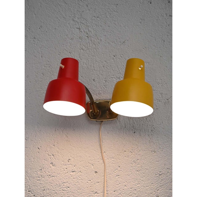 Vintage wall lamp with two yellow and red chromed metal diffusers, flexible brass arms. Scandinavian wall lamp from the...