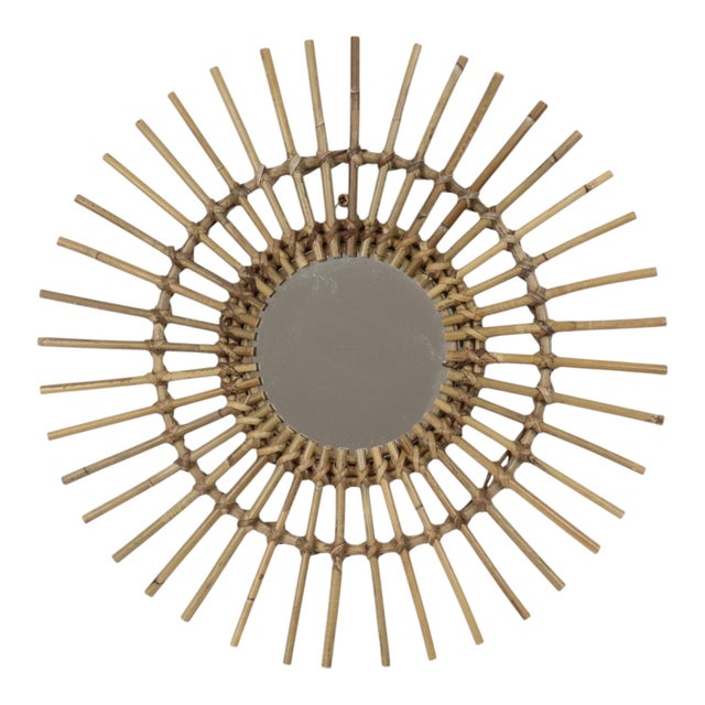 Charming vintage sunburst mirror crafted from rattan and bamboo; a boho design from circa the 1960s, France. with its...